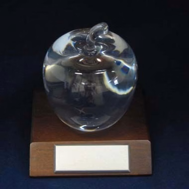 OPTICAL GLASS APPLE AWARD WITH WALNUT WOOD BASE.