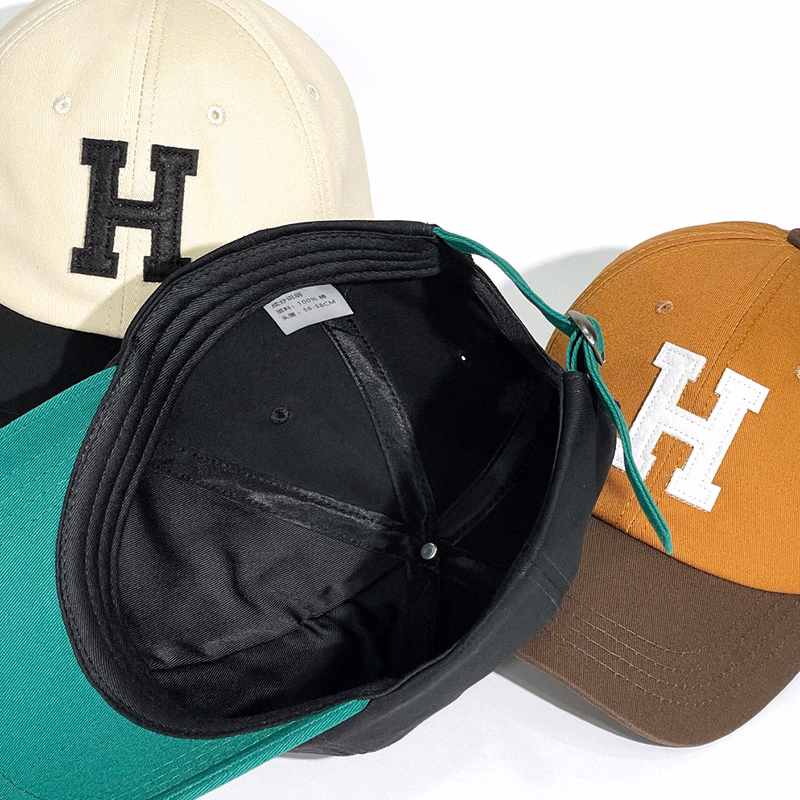 Spliced two-color peaked cap