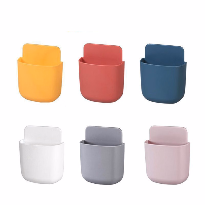 Wall-mounted adhesive remote control storage box